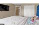 Spacious bedroom with large closet, TV, and access to a bathroom at 7356 Blue Jay Way, Union City, GA 30291