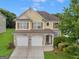 Beautiful two-story house with a three-car garage and landscaping at 7356 Blue Jay Way, Union City, GA 30291