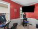 Game room boasts arcade games, large TV, and red walls at 7356 Blue Jay Way, Union City, GA 30291
