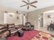 Spacious living room featuring a brown leather sectional sofa and a red carpet at 7356 Blue Jay Way, Union City, GA 30291