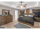 Spacious main bedroom with dresser, large bed, and ceiling fan at 7356 Blue Jay Way, Union City, GA 30291