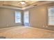 Spacious bedroom with neutral walls and carpet, featuring multiple windows with blinds at 901 Arbor Way, Mcdonough, GA 30253