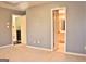 Bedroom with neutral walls and carpet, showing access to bathroom and laundry area at 901 Arbor Way, Mcdonough, GA 30253
