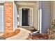 Front door entry to a home with brick and siding at 901 Arbor Way, Mcdonough, GA 30253