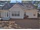 Rear view of a single-story house with double doors and a small patio at 901 Arbor Way, Mcdonough, GA 30253