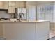 Bright kitchen with white cabinets, stainless steel appliances, and tile floor at 901 Arbor Way, Mcdonough, GA 30253