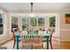 Sunlit breakfast nook with a turquoise table and view to the backyard at 210 Timber Laurel Ct, Lawrenceville, GA 30043