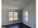 This bedroom features grey walls, wood-look floors and bright, natural light at 9418 Sleepy Hollow Ln, Jonesboro, GA 30238