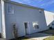 House exterior featuring gray siding and small patio at 9418 Sleepy Hollow Ln, Jonesboro, GA 30238