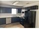 Kitchen with black cabinets, white countertops and stainless steel appliances at 9418 Sleepy Hollow Ln, Jonesboro, GA 30238