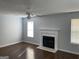 Living room with wood-look floors, fireplace and natural light at 9418 Sleepy Hollow Ln, Jonesboro, GA 30238