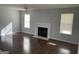 Living room with hardwood floors, fireplace, and two windows at 9418 Sleepy Hollow Ln, Jonesboro, GA 30238