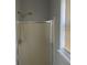 Shower stall with glass door and handheld shower head at 9418 Sleepy Hollow Ln, Jonesboro, GA 30238
