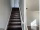Dark wood staircase leading to the second floor at 9418 Sleepy Hollow Ln, Jonesboro, GA 30238