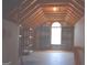 Unfinished attic with rafters, flooring, and open window at 213 Meridian Dr, Stockbridge, GA 30281