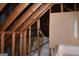 Unfinished attic featuring roof beams and insulation at 213 Meridian Dr, Stockbridge, GA 30281