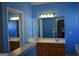 Bathroom featuring dual sinks, vanity lighting, and mirrors creating a functional and stylish space at 213 Meridian Dr, Stockbridge, GA 30281