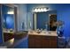 Bright blue bathroom featuring double sinks, large mirrors, and ample counter space at 213 Meridian Dr, Stockbridge, GA 30281