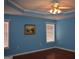 Comfortable bedroom with natural light from windows, hardwood floors, and a calming blue color scheme at 213 Meridian Dr, Stockbridge, GA 30281