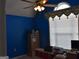 Bright blue bedroom with a large window for natural light and a simple, functional design at 213 Meridian Dr, Stockbridge, GA 30281