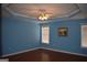 Spacious bedroom with hardwood floors, crown molding, and a ceiling fan, providing comfort and style at 213 Meridian Dr, Stockbridge, GA 30281