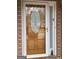 The front door is made of wood and has an oval window at 213 Meridian Dr, Stockbridge, GA 30281