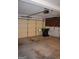 An empty, spacious garage with door and garage door opener at 213 Meridian Dr, Stockbridge, GA 30281