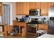 A kitchen featuring wood cabinetry, stainless steel appliances, and granite countertops at 213 Meridian Dr, Stockbridge, GA 30281