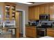 Traditional kitchen featuring wood cabinets, stainless steel appliances, and granite countertops at 213 Meridian Dr, Stockbridge, GA 30281