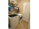 This laundry room includes washer, dryer, and shelving at 213 Meridian Dr, Stockbridge, GA 30281
