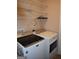 Laundry room with modern, matching washer and dryer and wire shelving at 213 Meridian Dr, Stockbridge, GA 30281