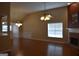 A living room with a fireplace, ceiling fan and hardwood floors at 213 Meridian Dr, Stockbridge, GA 30281