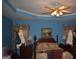 Cozy main bedroom featuring a ceiling fan, floral curtains, and warm, inviting decor at 213 Meridian Dr, Stockbridge, GA 30281