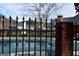 Community pool enclosed by wrought iron fence, providing a refreshing outdoor amenity at 213 Meridian Dr, Stockbridge, GA 30281