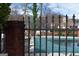 Community pool with wrought iron fence surrounded by lawn and greenery at 213 Meridian Dr, Stockbridge, GA 30281