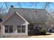 Home's rear exterior showcases siding, a well-kept roof, and a backyard with mature trees and tidy landscaping at 213 Meridian Dr, Stockbridge, GA 30281