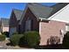 Well-maintained brick home with clean gutters, mature landscaping, and a well-manicured lawn at 213 Meridian Dr, Stockbridge, GA 30281