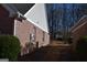Brick and siding home with lush greenery, well-maintained yard, and side access to backyard at 213 Meridian Dr, Stockbridge, GA 30281