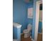 Bathroom featuring a classic white toilet and white cabinet space, maximizing functionality at 213 Meridian Dr, Stockbridge, GA 30281