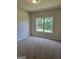 Spacious bedroom with neutral carpeting and a large window at 5711 Laney Dr # Ln24, Rex, GA 30273