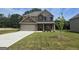 Brick house with two-car garage and landscaped lawn at 5711 Laney Dr # Ln24, Rex, GA 30273