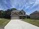 Two-story brick home with a two-car garage and manicured lawn at 5711 Laney Dr # Ln24, Rex, GA 30273