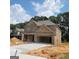 Brick two-story house with a two-car garage and new construction at 5711 Laney Dr # Ln24, Rex, GA 30273