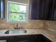 Kitchen sink and granite countertop with beige backsplash at 5711 Laney Dr # Ln24, Rex, GA 30273