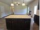 Kitchen island with granite countertops and dark brown cabinets at 5711 Laney Dr # Ln24, Rex, GA 30273