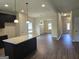 Kitchen with an open floor plan, island, and hardwood floors at 5711 Laney Dr # Ln24, Rex, GA 30273
