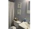 Clean bathroom with gray walls and a plaid shower curtain at 228 Cornell Ct, Villa Rica, GA 30180