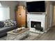 Living room with fireplace, TV, and wooden cabinet at 228 Cornell Ct, Villa Rica, GA 30180