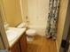 Full bathroom featuring a shower-tub combo, toilet, vanity and a stylish shower curtain at 2590 Wellington Walk Pl, Lithonia, GA 30058