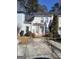 Two-story townhouse with a concrete driveway and small front yard at 2590 Wellington Walk Pl, Lithonia, GA 30058